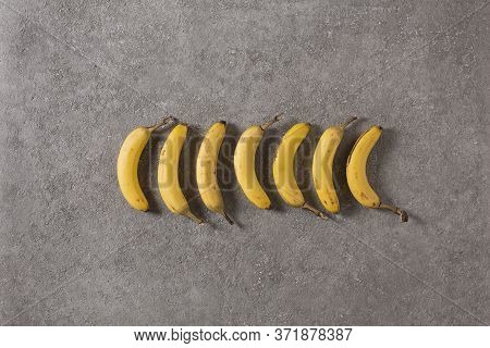 Ripe Bananas On Gray Concrete Background. Interior Photo. Photoart.