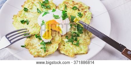 Vegetable Zucchini Pancakes With Poached Egg On White Plate. Long Wide Banner