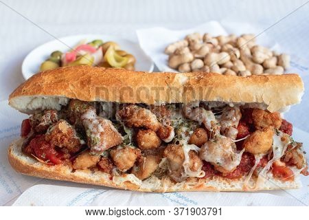 Chicken With Cheese Tomato And Spices Olives Pepper And Peanuts On A Plate