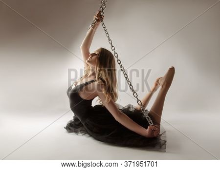 Slender Girl Dancing With A Large Chain In An Incredible Ballerina Pose