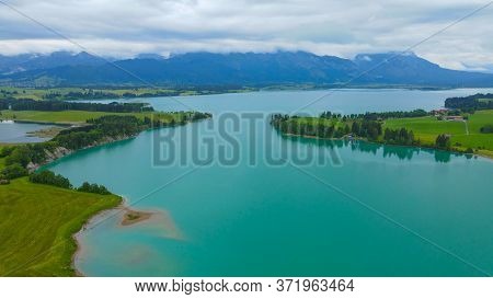 Aerial View Over Lake Forggensee At The City Of Fuessen In Bavaria Germany