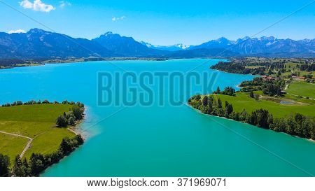 Aerial View Over Lake Forggensee At The City Of Fuessen In Bavaria Germany