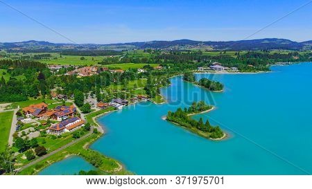 Aerial View Over Lake Forggensee At The City Of Fuessen In Bavaria Germany