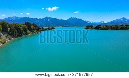 Aerial View Over Lake Forggensee At The City Of Fuessen In Bavaria Germany