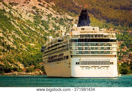 Cruise Ship In The Gulf Of Boko Kotor On The Adriatic Sea In The Midst Of Amazing Mountains