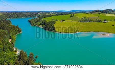 Aerial View Over Lake Forggensee At The City Of Fuessen In Bavaria Germany