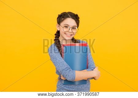 Library Focused On Developing Creativity. Happy Girl Hold Library Books. Walking Encyclopedia. Schoo