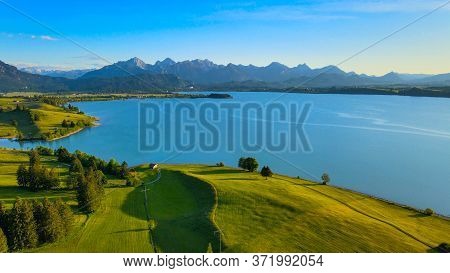 Aerial View Over Lake Forggensee At The City Of Fuessen In Bavaria Germany