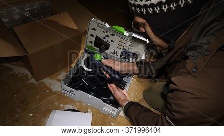 Strasbourg, France - Mar 3, 2020: Testing Start Button - Overhead View Of Worker Male Unboxing Parce