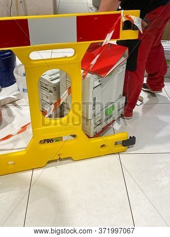 Kehl, Germany - Feb 17, 2020: Male Worker Feets Near Yellow Protection Sign And Multiple Festool Sys