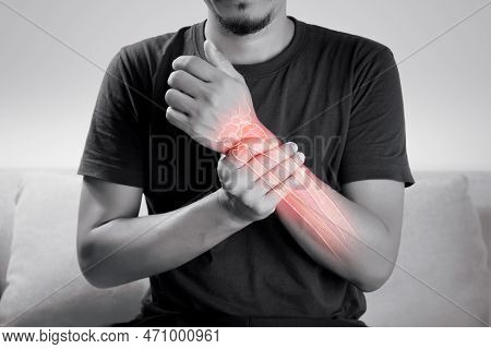 A Man Hand Bone Ache, People Suffering From Pain In Wrist On A Gray Background. Diseases Of The Elbo