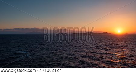 Rocky Island On Mediterranean Sea. Rinia Near Mikonos, Greece, Europe. Nature Background Panorama. S