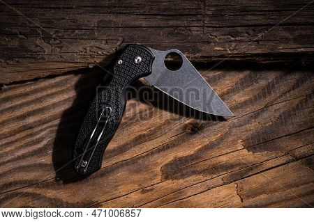 Folding Pocket Knife On A Wooden Background. Vintage Photo Of A Knife. Knife In Folded Position. Kni