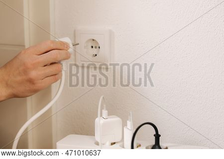 The Extension Cord Filled With Chargers Is Connected To A 220v Outlet