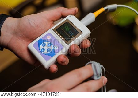 Man Using Pulse Oximeter Measures Oxygen Saturation Level, Health Care Monitoring Concept. Pulse Oxi