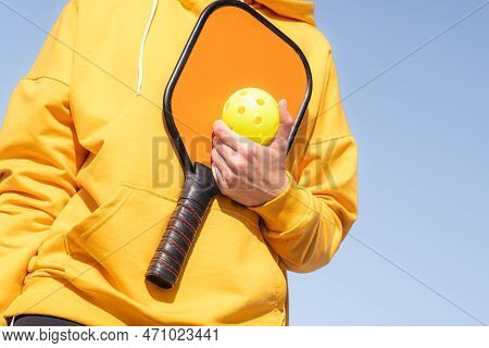Pickleball Paddle And Yellow Ball Close Up, Woman Playing Pickleball Game, Hitting Pickleball Yellow