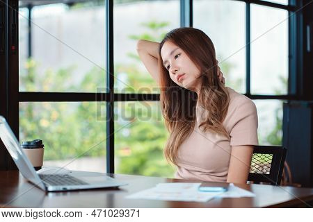 Asian Woman Having Neckache During Working With Laptop Computer In Office, Business Woman Work Hard 