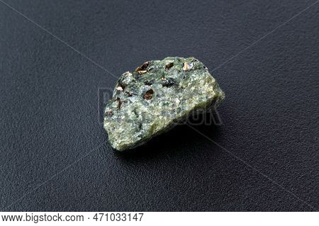 Rock With Peridot Olivine Mineral, Black Background. Close-up