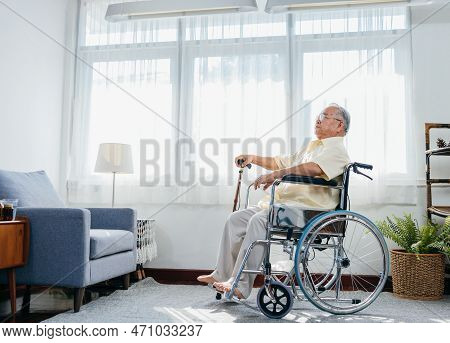 Asian Senior Old Man Sitting On Wheelchair Walking With Walker Cane Stick In Nursing Home, Elderly M