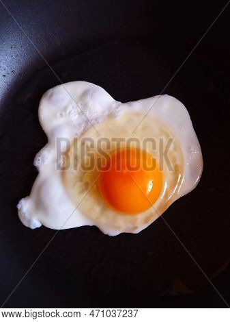 Chicken Egg In A Frying Pan Close Up Top View.