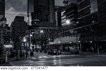 Toronto, Canada - 07 01 2022: Summer Night View Along Simcoe Street With People And A Car Waiting On