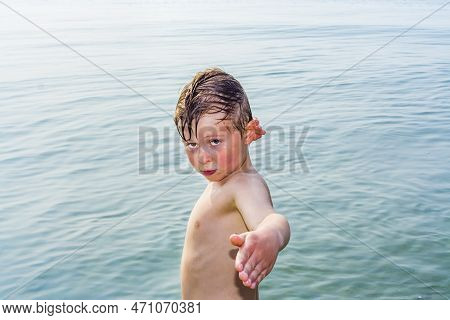 Cute Boy Posing In The Water Of The Beach In Venice, Italy.