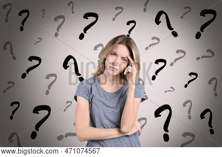 Amnesia Concept. Woman Trying To Remember Something. Question Marks On Color Background Symbolizing 