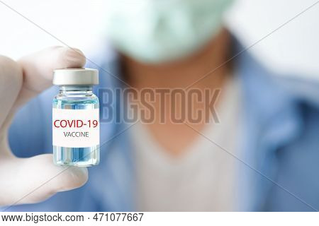 Doctor Holding Bottle  Blue Vaccine Covid 19 At The Hospital. Health And Medical Concepts