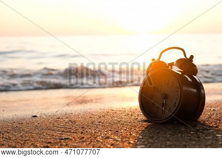 Morning Of A New Day, Alarm Clock  On The Beach Sunlight In Morning. Health Concept.