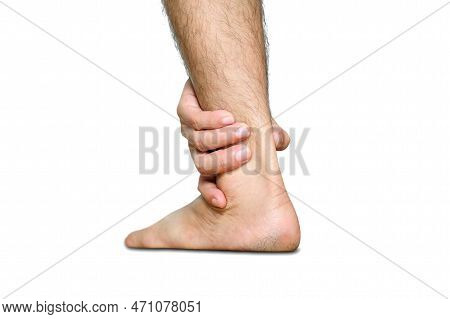 Black And White Photo.ankle Pain Man Sitting On Wooden Background Holding Her Feet. Health Concept.