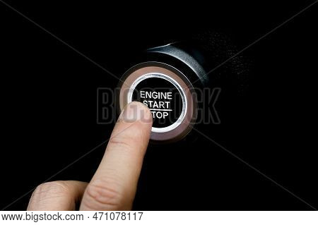 The Driver's Hand Is Pressing The Car Start Button. Concept Of Transportation And Technology