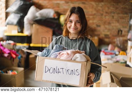 Volunteer Teengirl Preparing Donation Boxes For People. Donation Clothing For Refugees, Support Of W