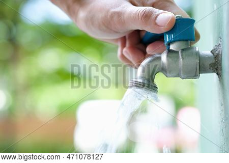 Hand Of Woman She Was Using Her Hand To Shut The Flowing Water From Faucet.water Saving And Energy I