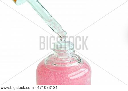 Dropping Serum Collagen Moisturizer Of Face Into Clear Yellow Bottle Soft Light Background. Protecto