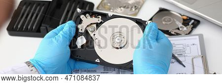 Technician Repairs Computer Hard Drive From Motherboard. Hard Drive Diagnostic Services Concept