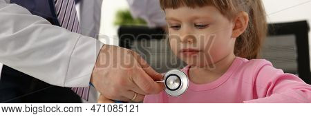 Hands Of Pediatrician Doctor Examining Small Child With Stethoscope. Pediatrics And Medicine Healthc