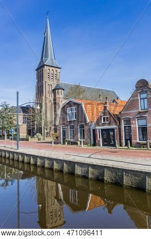 Balk, Netherlands - April 7, 2020: Historic Catholic Church At The Canal In Balk, Netherlands