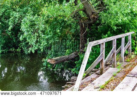 Beautifully Standing Old Wooden Bridge Over River In Colored Background Close Up