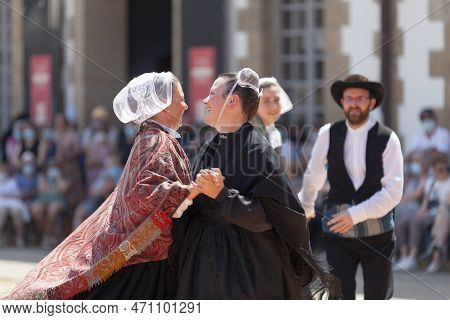 Morlaix, France - July 18 2021: Breton Dancers In Traditional Costumes And Headdresses.