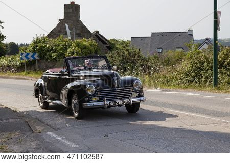 Kerlaz, France - July 17 2022: Retired Man Cruising In A Black Peugeot 203 Convertible.