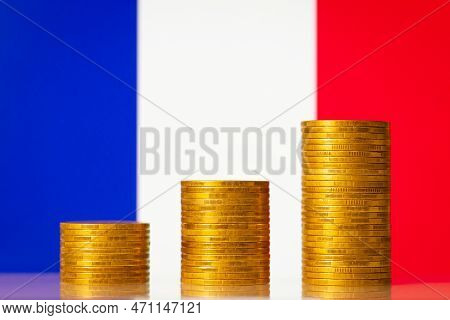 Money Coins Stacks In Rising Order In Front Of France Flag. Development Of Economy Of France Concept