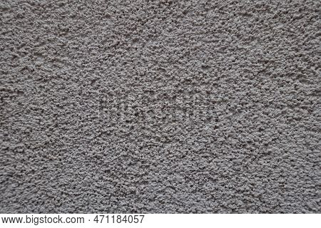 Close View Of Dusty Wall With Coarse Light Gray Roughcast Finish