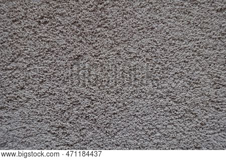 Macro Of Dusty Wall With Coarse Light Gray Roughcast Finish