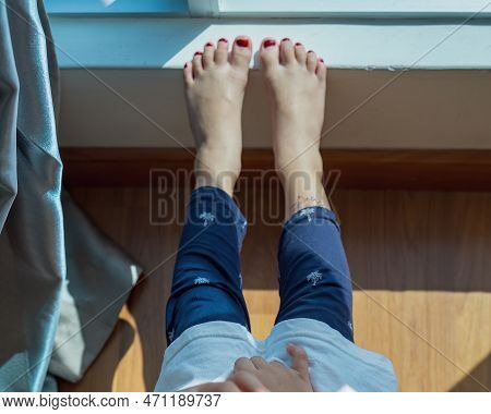 Feet With Henna In A Bright Sunlight On The Floor. Drying Henna At Home.