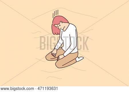 Lost Woman Kneels With Head Bowed On Sand Dunes In Wilderness, Suffering From Thirst And Exhaustion.