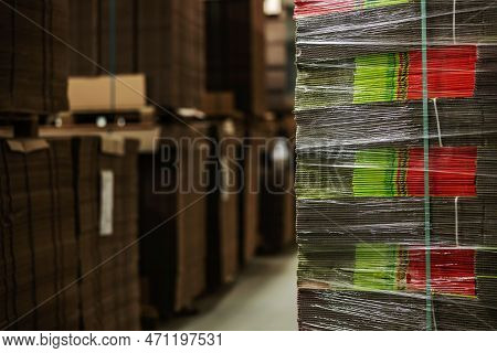 Stocks Of Unpacked Cardboard Boxes Wrapped In Transparent Stretch Film. Stocks Of Cardboard For Pack