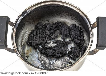 A Stainless Steel Pot With Burnt Food From Being Left On The Stove On White Background. Black Burns 