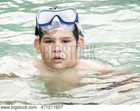 Teenager Boy Wearing Mask Swimming In The Pool. Happy Holiday Concept. Cute Happy Little Boy Swimmin