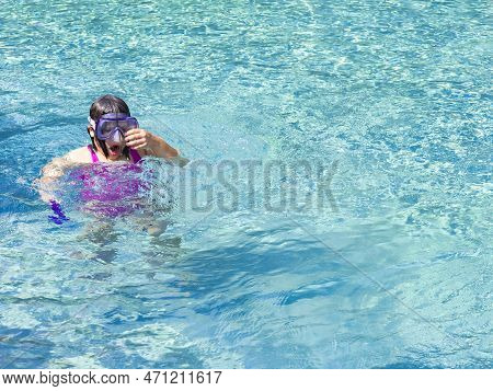 Teenager Girl Wearing Mask Swimming In The Pool. Happy Holiday Concept. Cute Happy Little Boy Swimmi