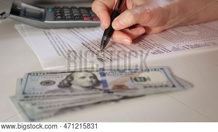 Filling The Amount On A 1040 And W9 Individual Tax Form Are Placed On Desk Of American Citizen.